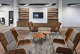 room with white walls and brown furniture