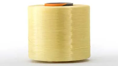 A large spool of shiny, pale yellow thread on a white background.