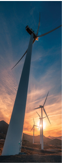 Beautiful cloudy sunset with clean energy wind turbines